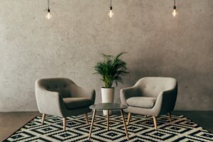 modern interior with vintage furniture in loft style with concrete wall on background